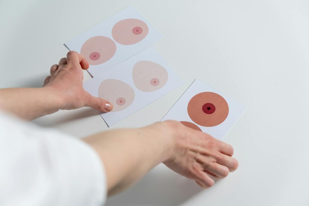 person holding red heart paper