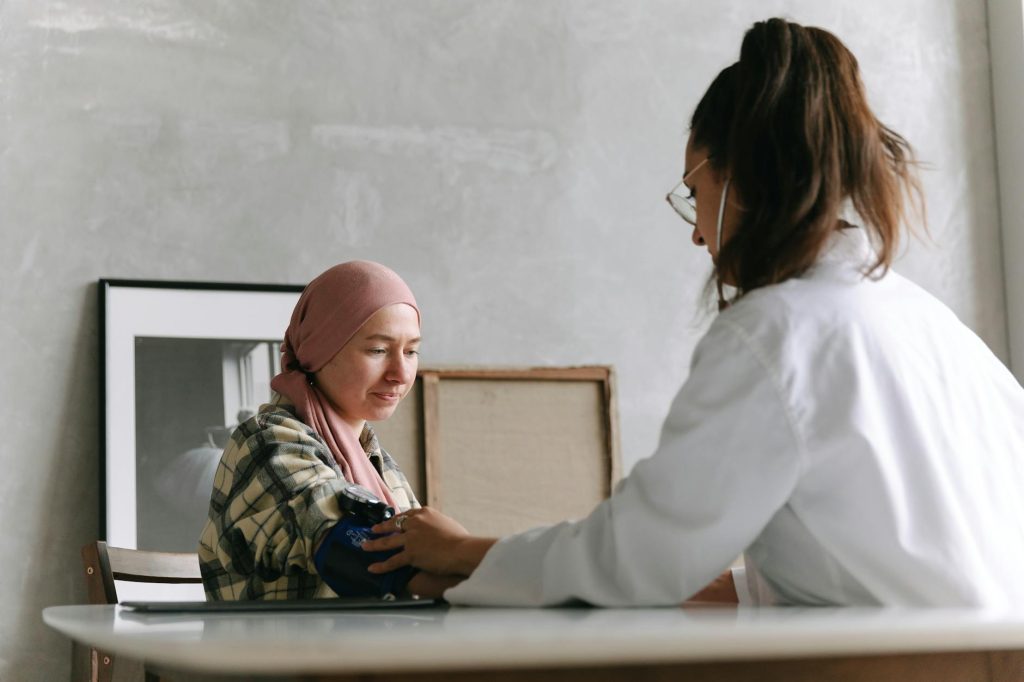 a doctor taking blood pressure of a patient